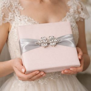 Bride holding our pale pink silk box for invitation cards