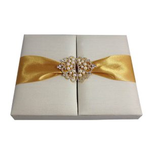 Luxury ivory silk wedding box with golden ribbon and pearl brooch embellishment