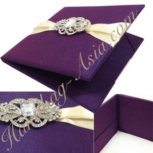 Luxury folio invitation in purple with vintage brooch