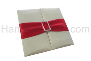 Embellished ivory wedding folder with red ribbon and buckle
