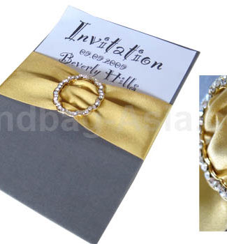silk invitation pad with golden buckle and ribbon