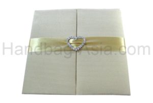 Heart buckle embellished wedding folder in ivory with pockets for cards