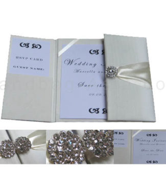 Embellished ivory wedding invitations with brooches