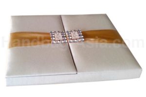 Luxury wedding invitation box in ivory with golden ribbon