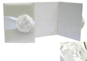 Luxury ivory and white wedding portfolio with pockets and textile flower embellishment