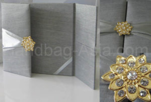 silver wedding portfolio with golden star brooch