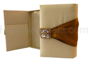 Cream and gold wedding box with crystal brooches and silk cover
