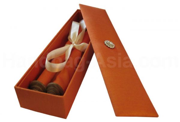 orange silk box with scroll invitation