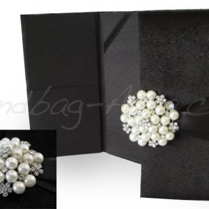 Black velvet invitation with pearl brooch