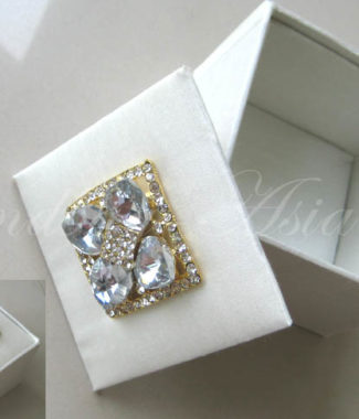 ivory silk gift box with golden brooch