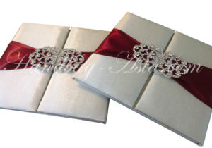 ivory silk folio with red ribbon and clasp