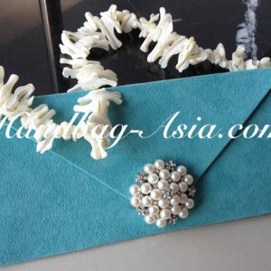 embellished evening clutch bag with pearl brooch