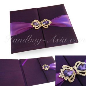 eggplant color wedding folder with crown pair brooches