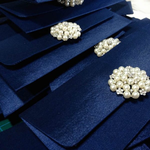 luxury navy blue wedding envelope with pearl brooch
