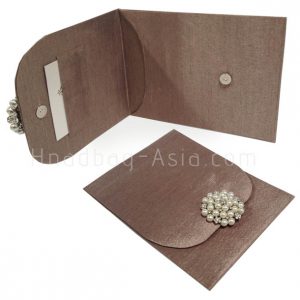 bronze wedding envelope with pearl brooch