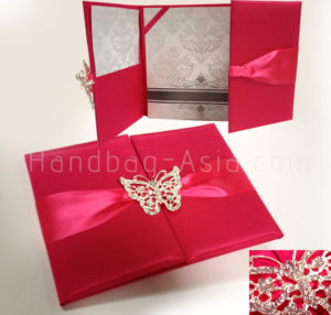deep pink wedding pocket folder with butterfly brooch