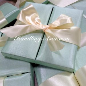 mint green boxed wedding invitation with ivory bow