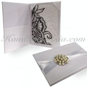 white silk wedding folder with pearl brooch