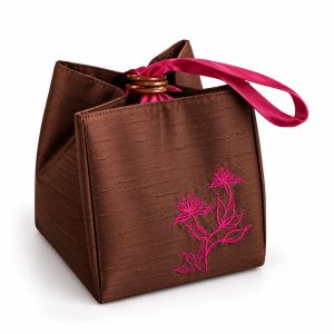 Embroidered silk cube bag in fuchsia pink and brown with Thai lotus flower embroidery, coconut ring closure and wrist handle.