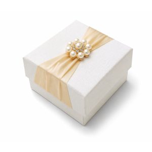 Ivory silk covered wedding favor box with pearl button brooch