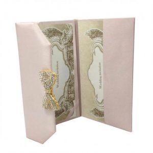 Luxury blush pink wedding envelope with brooch