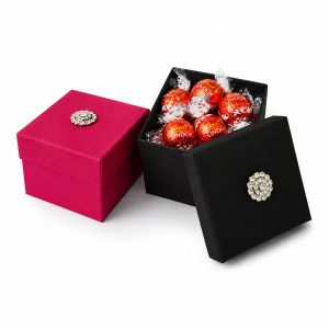 Fuchsia pink and black silk favor box with crystal button brooch
