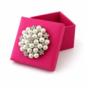 fuchsia silk favor box with large pearl brooch