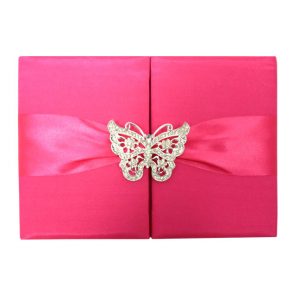 Fuchsia wedding invitation with butterfly brooch
