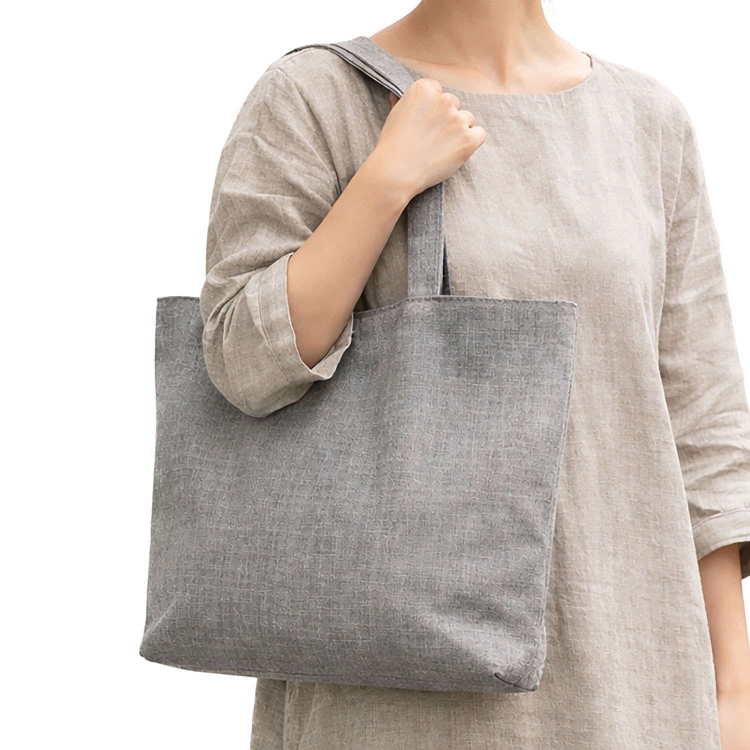 Women holding our grey linen tote bag