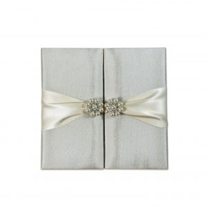 Gatefold silk folder with pearl pair brooch embellishment and ivory ribbon
