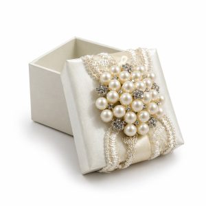 ivory silk favor box with large pearl and embroidery sash