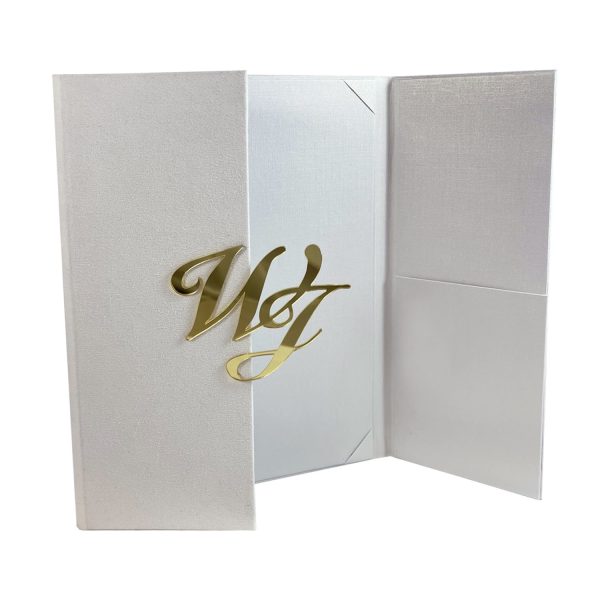 White suede gatefold invitation folio with large mirror gold monogram