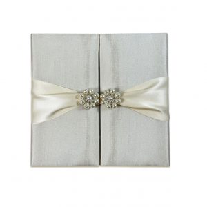 silk wedidng invite with pearl brooch embellishment