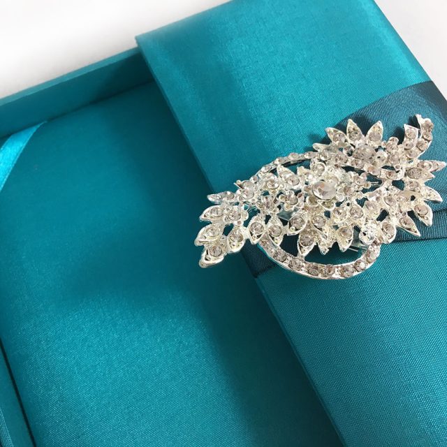 Brooch embellished teal silk gatefold invitation box