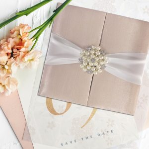 Gatefold wedding invitation with pearl brooch embellishment