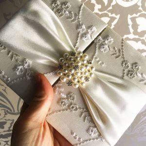 luxury lace invitations with pearl brooch