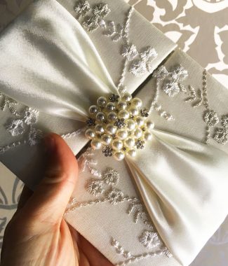 luxury lace invitations with pearl brooch