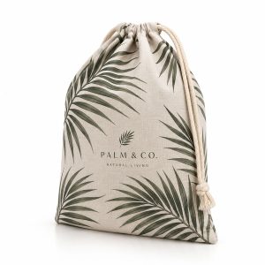 Natural linen drawstring gift bag with custom full-color DTF printed design and cotton ribbon closure.