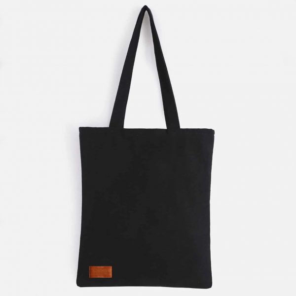 Black canvas tote bag with leather badge