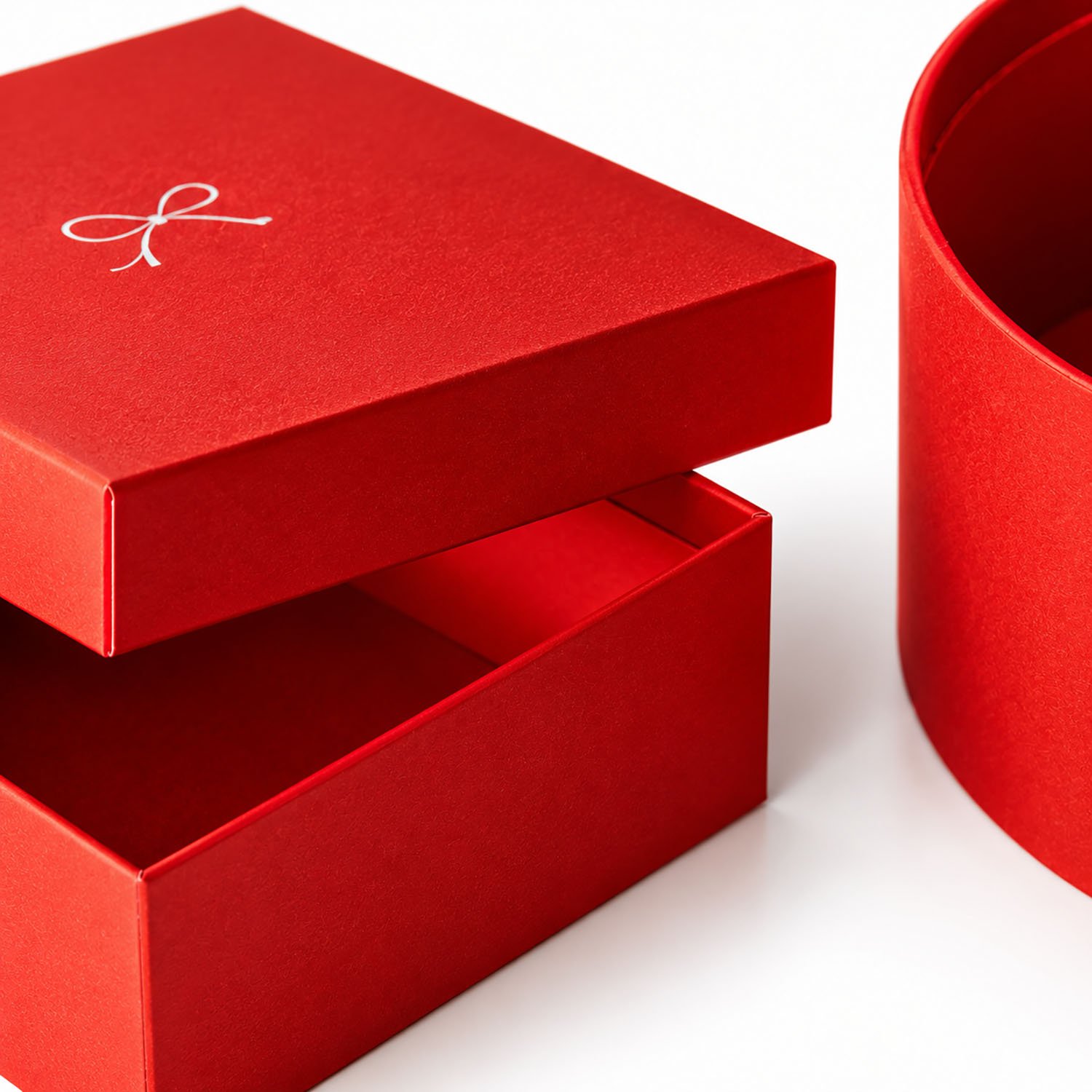 Close-up of premium red rigid paper gift boxes featuring matte paper finishes, removable lids, and elegant white custom logo printing.