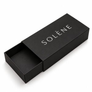 Luxury matte black rigid drawer box partially open with custom SOLÈNE white printed logo and sliding paperboard tray