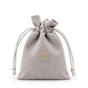 Grey micro suede jewelry drawstring bag with custom gold foil stamped logo for luxury jewelry packaging.