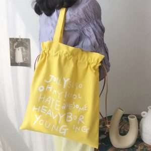 Yellow cotton shoulder bag with white graphic print
