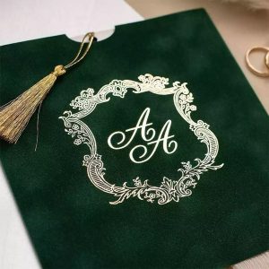 Green velvet sleeve invitation with custom foil stamped golden monogram