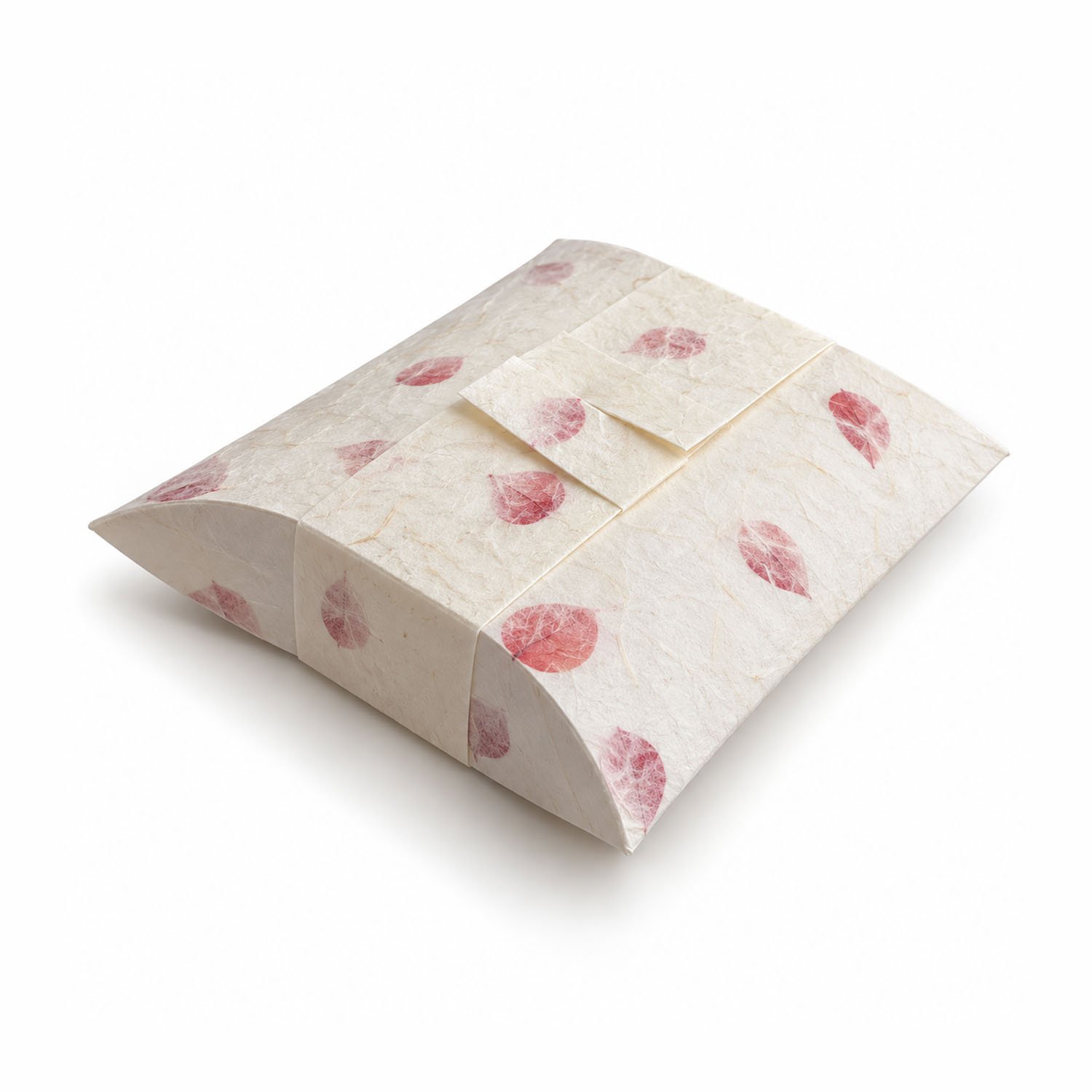 Ivory biodegradable pillow-style water burial urn with decorative paper band